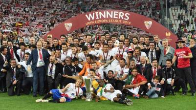 2013/14 Europa League winners Sevilla CF pose with the cup after their game against Benfica